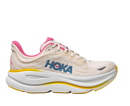 Beige running shoe with pink accents and yellow sole on a white background